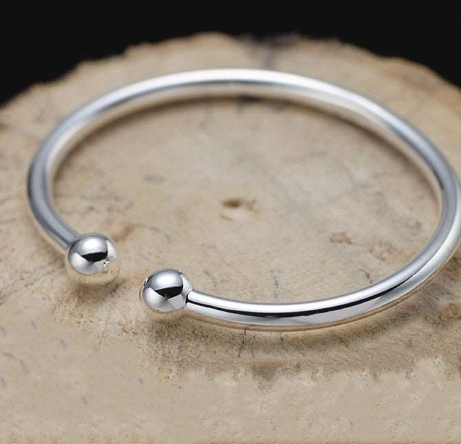 Open bangle in silver-toned copper with a Garlic-head Plain Surface and polished spherical ends