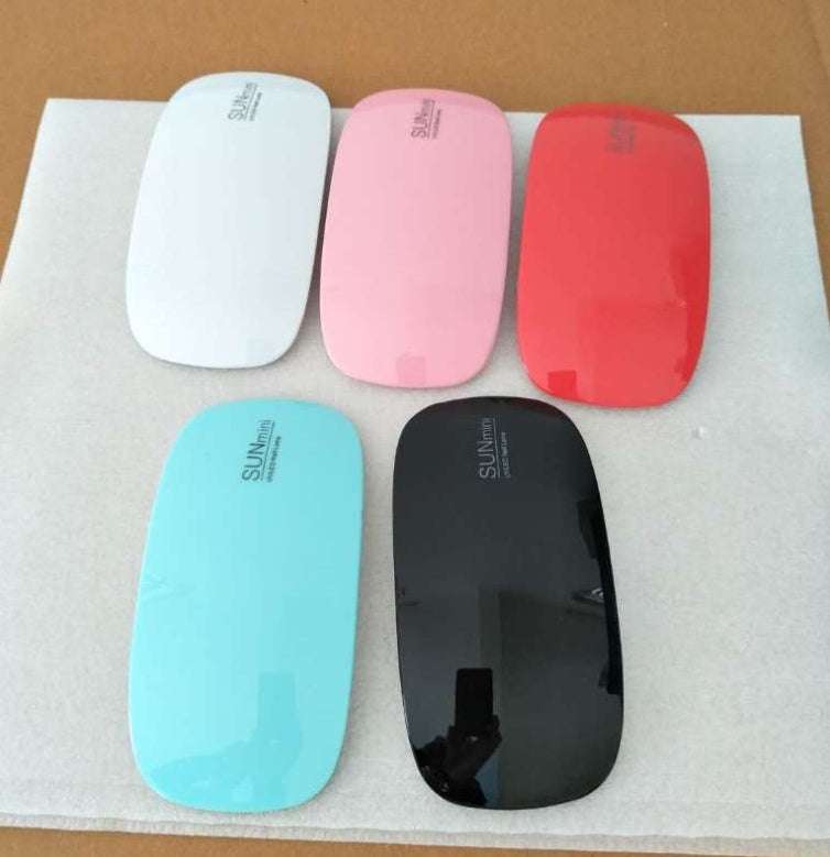 Light Therapy Machine in glossy white, pink, red, turquoise and black ABS with compact rounded design
