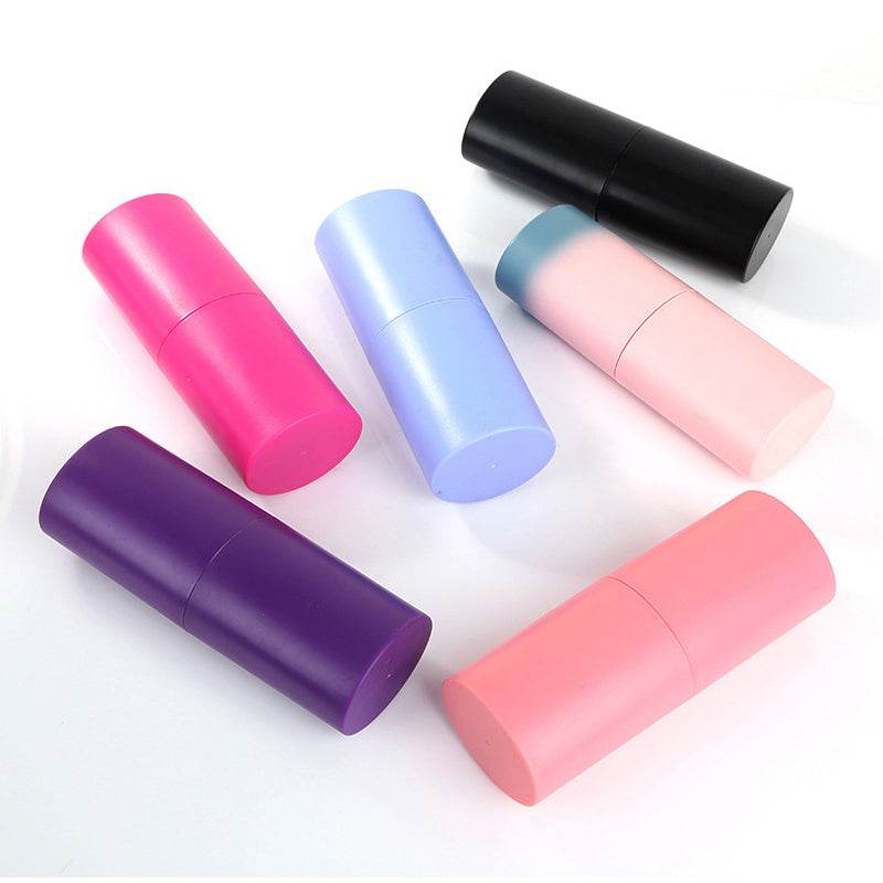 Makeup Brush Set with colourful plastic cylindrical cases in pink, purple, blue and black, shown closed