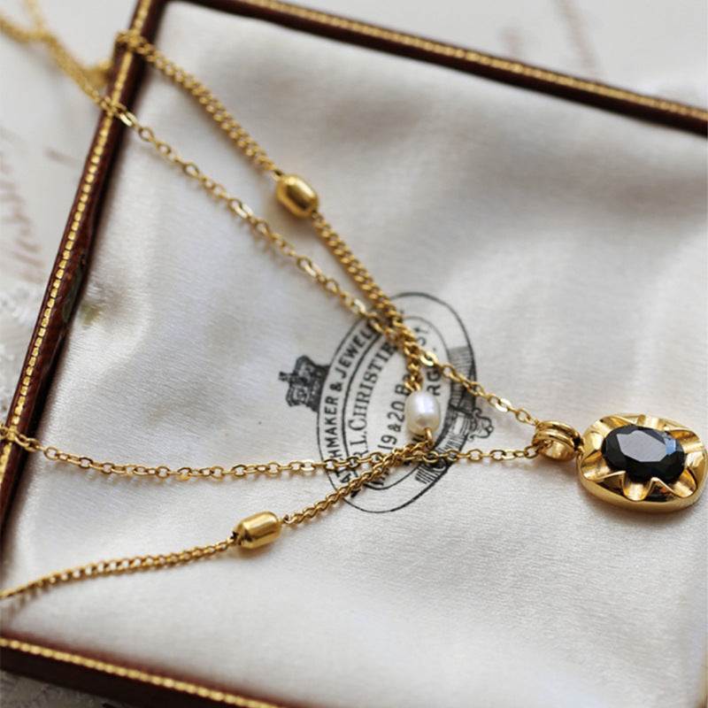 Cool-style 18K Gold-plated layered necklace in gold stainless steel, featuring a black faceted oval pendant and fine chains
