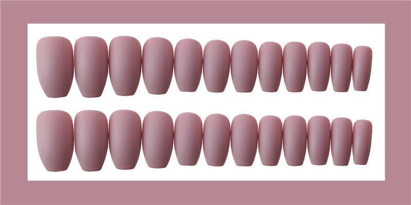 Wearable false nails in muted pink, smooth plastic with rounded shapes in assorted sizes for a natural fit
