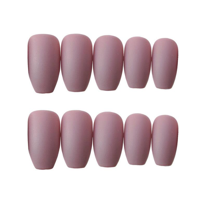 Wearable false nails in matte dusty rose plastic, featuring rounded square tips and assorted sizes for a uniform manicure set