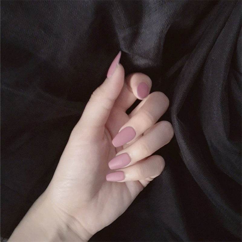 Wearable false nails in soft ballet pink, matte finish with long tapered almond-shaped tips for elegant styling