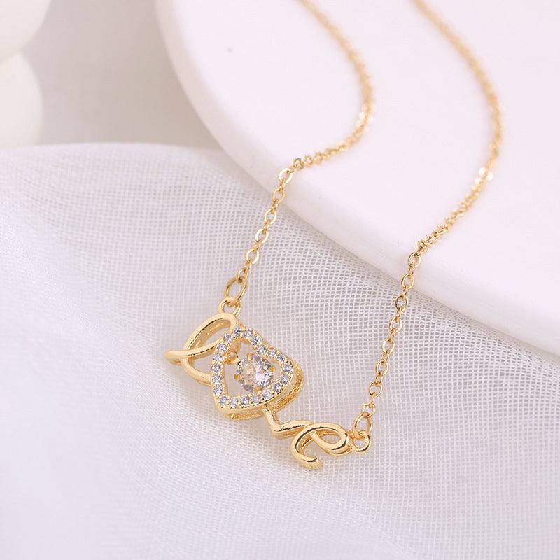 Necklace Valentines Day Gift in gold-tone metal with heart pendant, rhinestone accents, and LOVE lettering chains