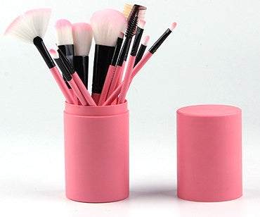 Makeup Brush Set with 12 pink plastic-handled brushes, soft white and pink bristles, and a matching storage case