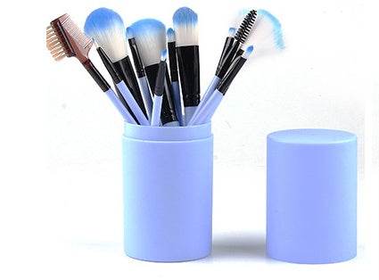 Makeup Brush Set with 12 blue and black rayon brushes, featuring fluffy heads and a matching storage barrel case
