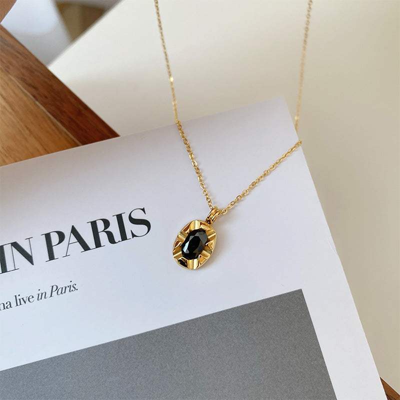 Cool-style 18K Gold-plated necklace with a fine gold chain and round black stone pendant in a textured setting
