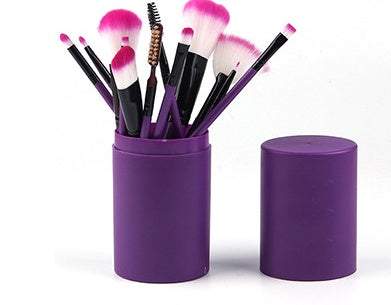 Makeup Brush Set with 12 purple plastic handles and soft pink-and-white synthetic bristles in a cylindrical holder