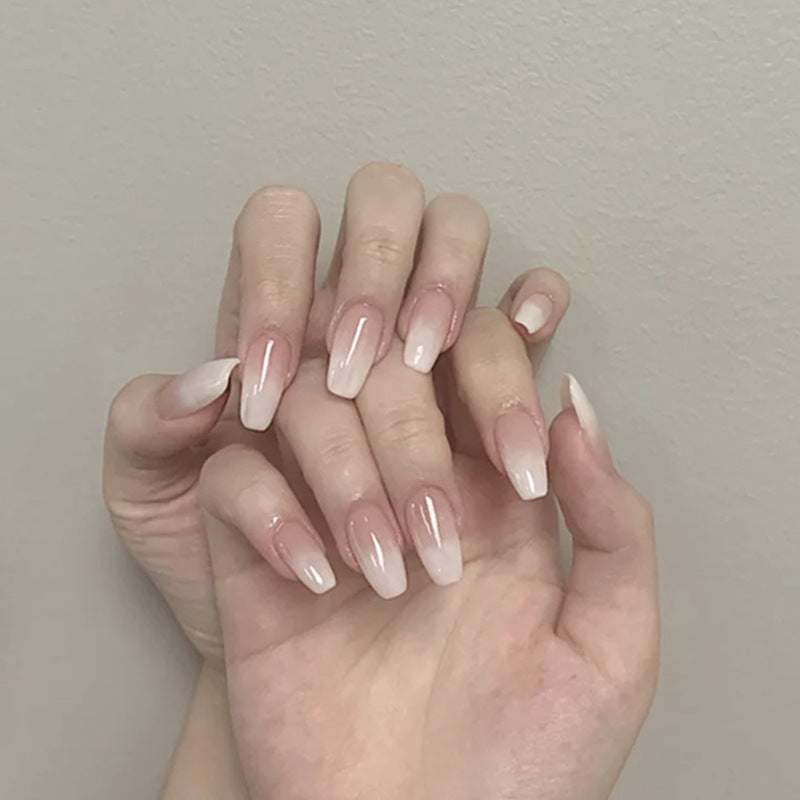 Wearable false nails in glossy ballet-white gradient, long almond shape with a smooth, elegant finish