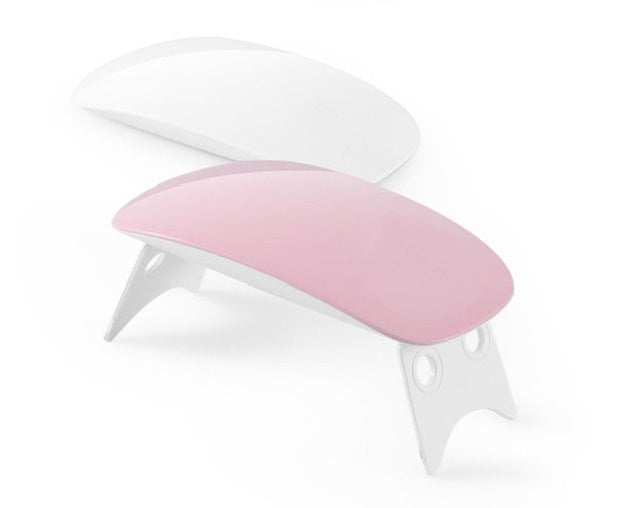 Light Therapy Machine with pink and white ABS shells, curved portable design, fold-out support legs, and USB power compatibility