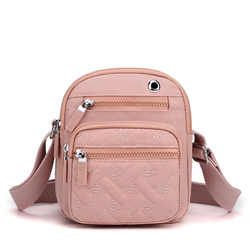 Crossbody bag in Solid Color pink nylon with quilted monogram pattern, multiple zippered pockets and adjustable strap
