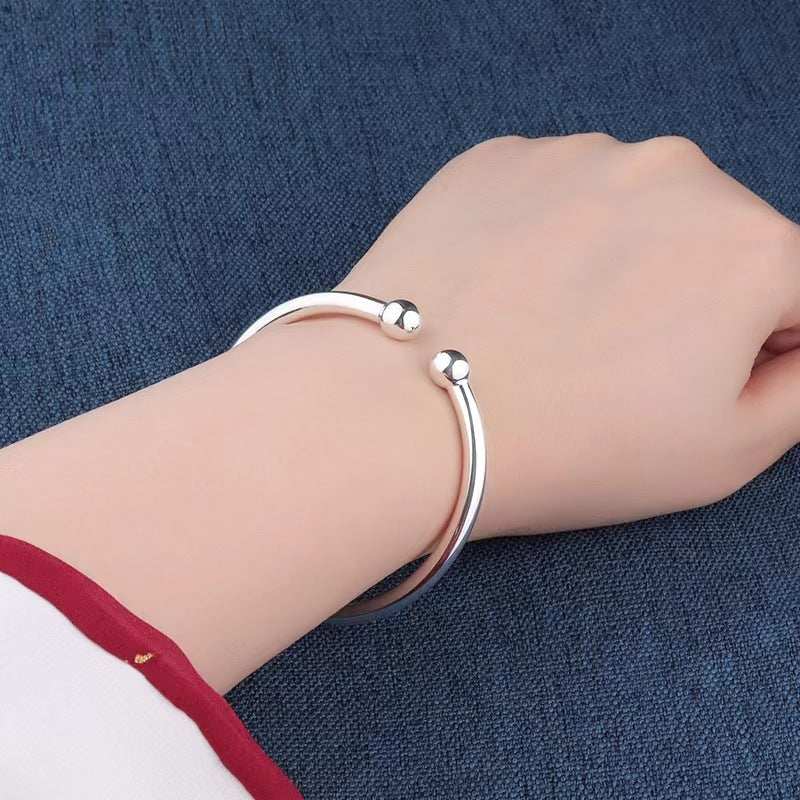 Garlic-head Plain Surface open bangle in polished silver-tone metal, featuring smooth round ends and a slim curved design