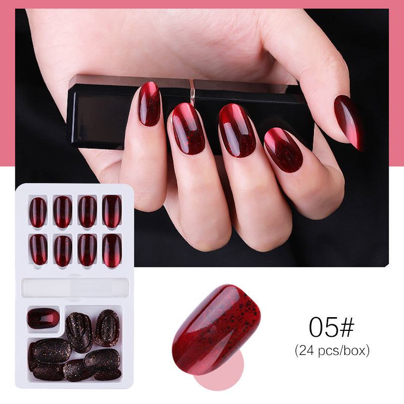 Reusable Stick-On-Nails in glossy burgundy red with black speckled glitter, assorted sizes and rounded tips