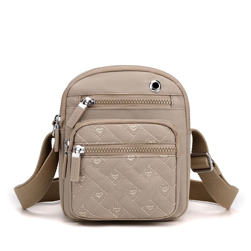 Crossbody bag in Solid Color taupe nylon with quilted logo pattern, multiple zip pockets and adjustable strap
