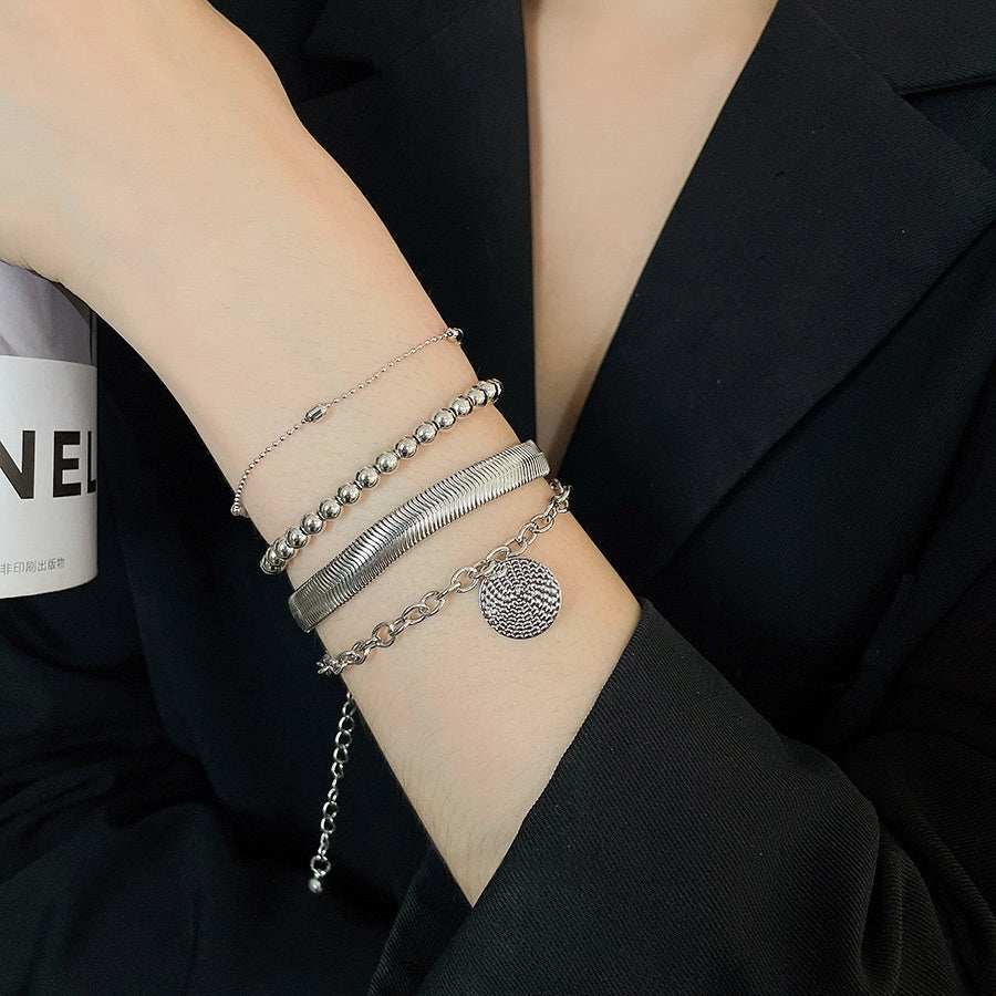 All-Match Round Pendant bracelet set in silver-tone metal, featuring layered chains, beads, ridged bands and a textured round charm