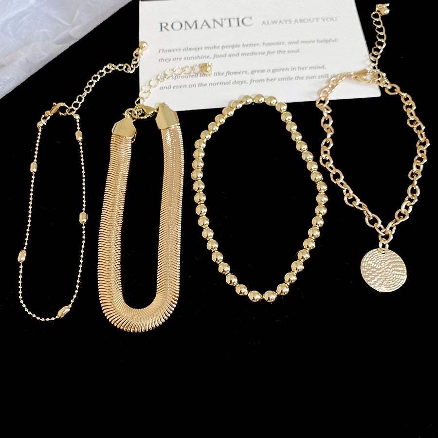 Bracelet set featuring an All-Match Round Pendant, gold-tone metal chains and textured geometric designs, four pieces