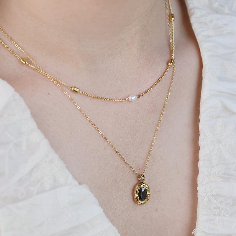 Cool-style 18K Gold-plated layered necklace with fine gold chains, pearl bead and oval black pendant detail
